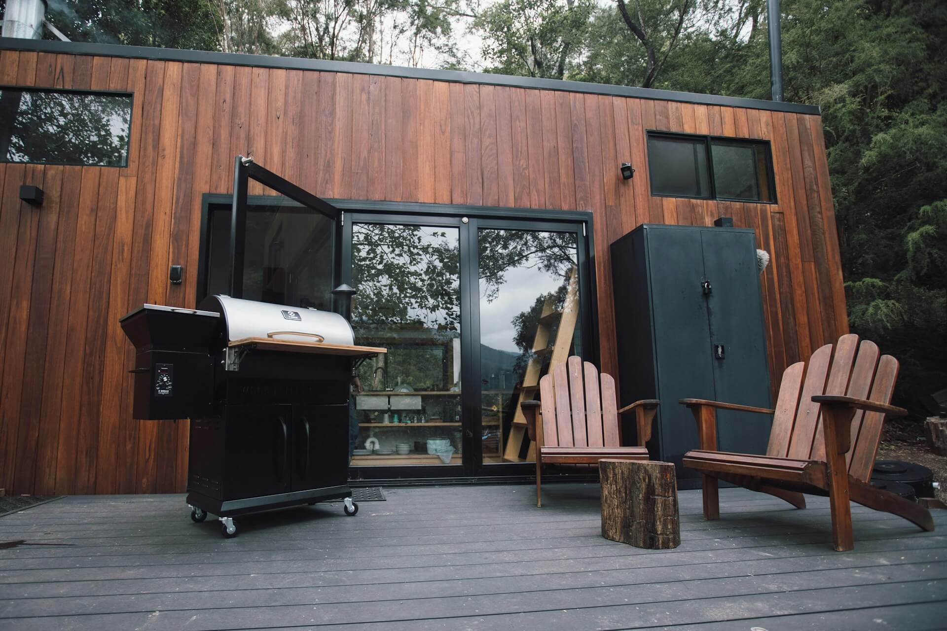 Outdoor smoker setup in backyard with smoke rising