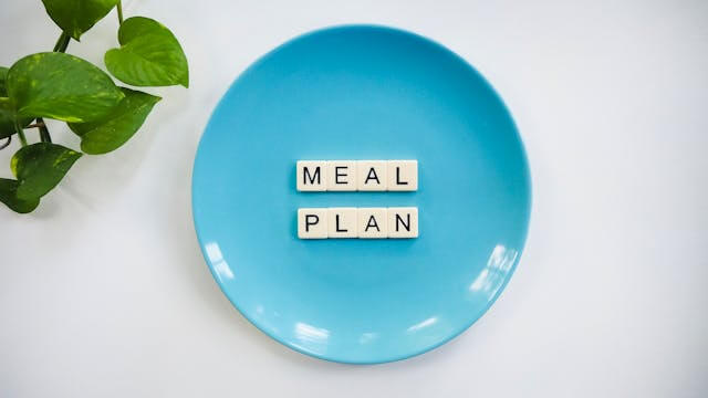 A blue plate with Scrabble tiles spelling 